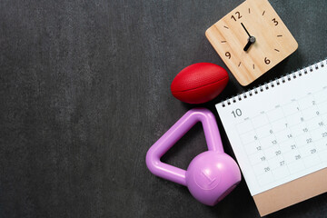 Time for exercising sport equipment on the black table background, healthy and workout concept