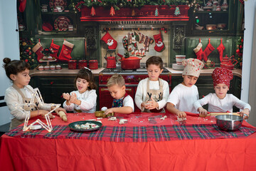 Children baking traditional christmas cookies in kitchen