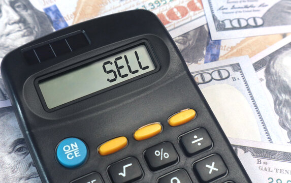 Sell on the calculator screen with dollar bills as the background - Powered by Adobe