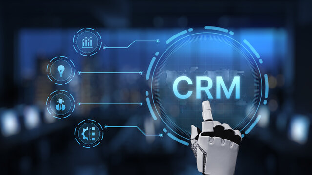 A robotic hand engages with a modern CRM system interface showcasing analytics and business features, symbolizing innovation and efficiency in technology. Synapse - Powered by Adobe