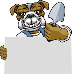 Fototapeta premium A gardener, farmer or handyman bulldog dog cartoon mascot man holding a gardening tool