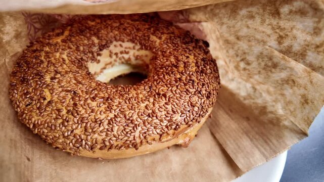 Enjoying a fresh sesame bagel with cream cheese