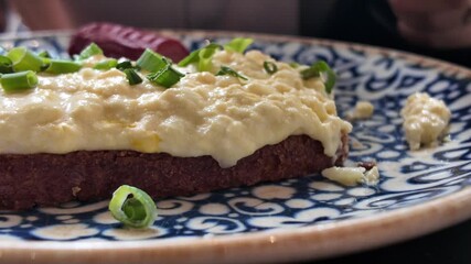 Delicious brunch plate with creamy topping and herbs