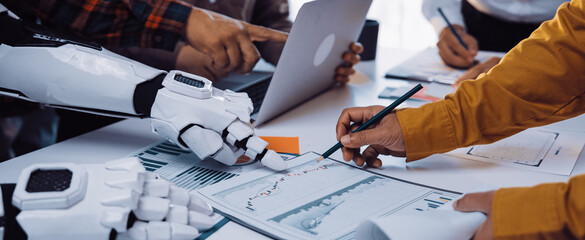 A dynamic scene of human hands and a robotic arm collaborating on data analysis and strategic discussions in a modern office setting, showcasing innovation.Noogenesis