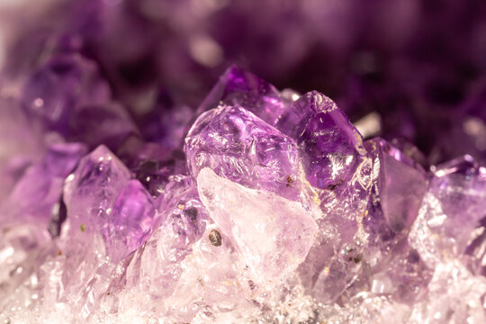Amethyst purple crystals. Gems. Mineral crystals in the natural environment. Texture of precious and semiprecious stones. Seamless background with copy space colored shiny surface of precious stones. - Powered by Adobe