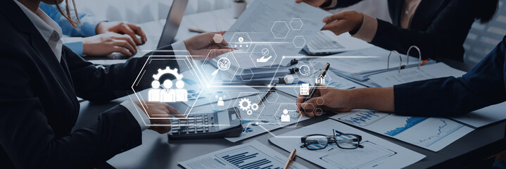 Business professionals collaborate on project analysis with digital interface overlay showcasing technological innovation and teamwork dynamics Trope.