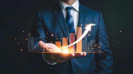 Businessman holding a glowing orange bar graph with rising arrow, symbolizing financial growth, business success, performance improvement, data analytics, and futuristic economic progress.