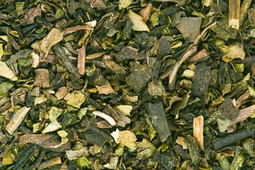 Extreme super macro 5x close-up of matcha green tea powder showing fine granular texture.