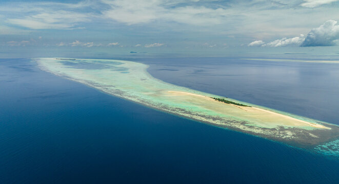 Aerial view of Timba Timba island with beach and coral reef. Tun Sakaran Marine Park. Borneo, Sabah, Malaysia.
