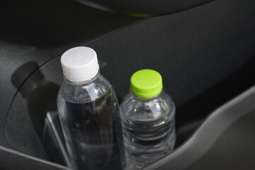 Drinking water in the car prepared for traveling