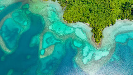 Naklejka premium Aerial view of lagoon with turquoise water in the bay of a tropical island. Borneo, Sabah, Malaysia.