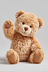 Fototapeta premium A cute, fluffy teddy bear with a light brown color and a friendly expression. The bear is sitting upright and waving one paw.