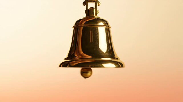Golden bell swinging slightly, announcing Christmas and holiday cheer. Classic New Year celebration symbol for festive event.