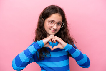 Little girl isolated on pink background With glasses making heart with hands