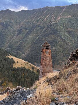 Medieval Stone Watchtower Above Forested Mountain Valley in Georgia