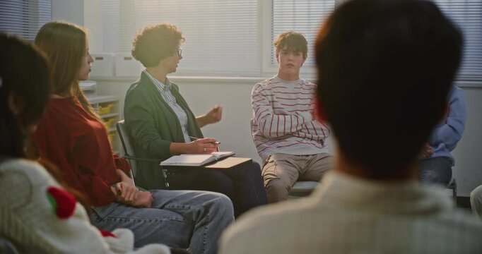 Teacher and Students Engage in Group Therapy inspired Discussion About Emotions and Stress. Concept Mental Health Education, Empathy, Mindfulness, and Emotional Resilience in Schools. Dolly Shot.