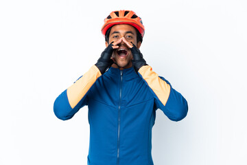 Young cyclist man with braids over isolated background shouting and announcing something