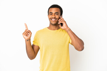 African American handsome man using mobile phone over isolated white background showing and lifting...