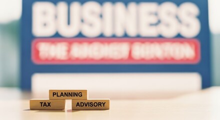 Wooden blocks spelling Tax, Planning, and Advisory against a blurred backdrop of a Business sign, symbolizing strategic financial guidance.