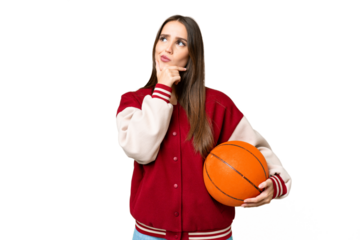 Young beautiful woman playing basketball over isolated chroma key background having doubts