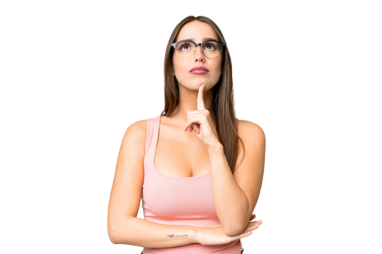 Young beautiful woman over isolated chroma key background With glasses and looking up
