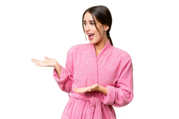 Young beautiful woman in a bathrobe over isolated chroma key background with surprise facial expression