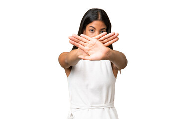 Young African american woman over isolated background making stop gesture with her hand to stop an act