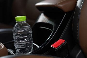 Drinking water in the car prepared for traveling