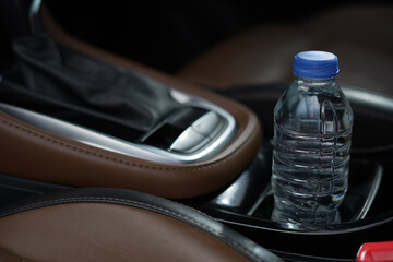 Drinking water in the car prepared for traveling