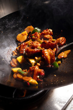 Cooking stir-fry shimp and veggies in a wok
