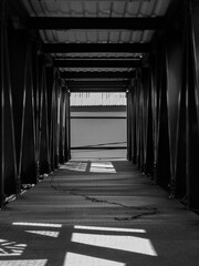 Black and White Industrial Walkway with Geometric Shadows
