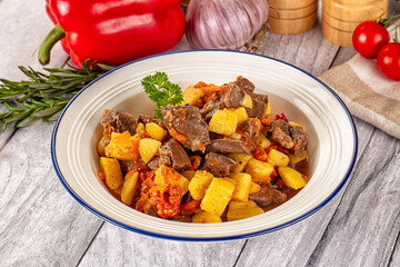 Rogiut with meat, potato and tomatoes