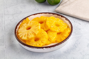 Sweet canned pineapple slices in syrope
