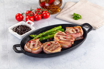 Tasty grilled pork medallion with bacon