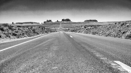 Monument Valley desert landscape captured in monochrome highlighting textures and shadows of rocks