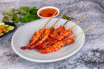 Grilled prawn skewer served sauce