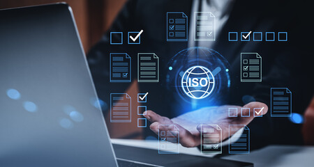ISO certification concept with digital document icons and checkmarks floating above a businessman's hand in a creative compliance interface design.