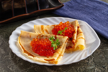 Russain traditional pancakes with red caviar