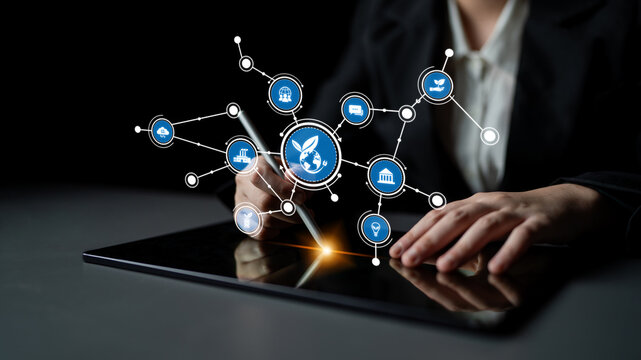 A businesswoman engages with a digital tablet, showcasing an innovative interface with icons that symbolize global networking and modern technology solutions. Tessel - Powered by Adobe
