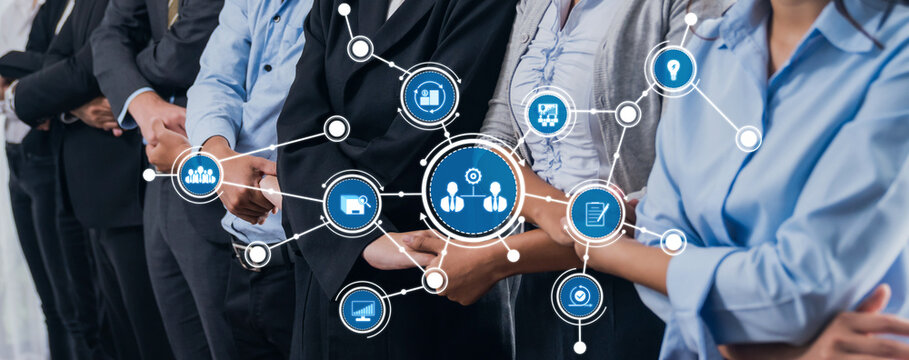 A group of business professionals stands in line, representing modern teamwork and communication in a corporate setting with digital networks and connections illustrating innovation. Amity