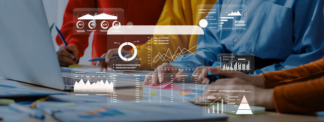 A group of professionals engages in collaborative data analysis, utilizing graphs and charts on a laptop to enhance business strategies and drive decisions forward. Trope