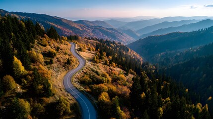 Winding Road Through Mountain Scenery: A picturesque mountain road weaves its way through a tapestry of autumn foliage and verdant forests, offering breathtaking vistas.