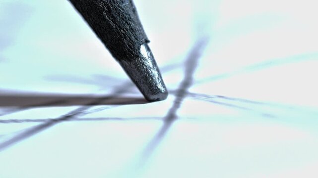 An extreme macro shot showing a pencil tip in motion, emphasizing the texture of the graphite and paper, suggesting intense focus and the start of a creative process