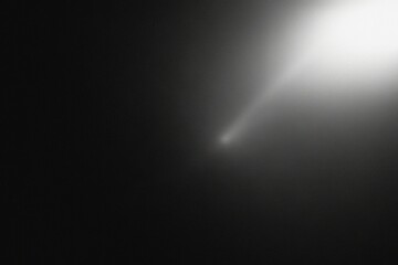 A bright comet streaks across the dark, vast expanse of space. The comet is illuminated by the...