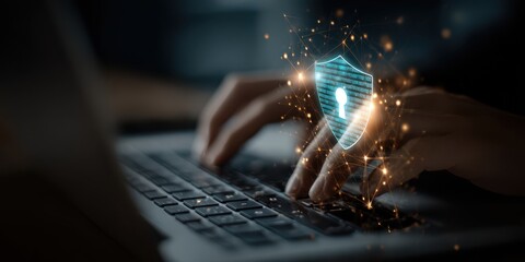 Close up of hands typing on a laptop with a digital shield icon, representing cybersecurity and data protection concept