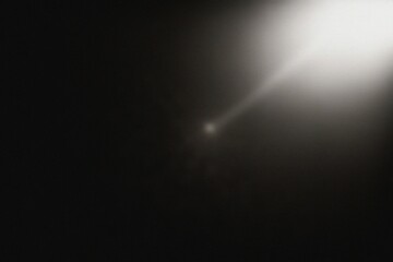 A captivating beam of light illuminates a mysterious dark background