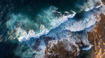 Aerial View of Waves Crashing: A stunning aerial perspective captures the dynamic energy of waves as they crash against the rocky shoreline, creating a mesmerizing display of nature's power.