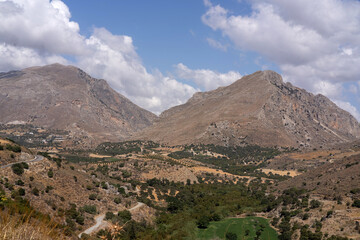 scenic landscape of the rugged Cretan mountains and valleys in Greece, captured on clear sunny day....