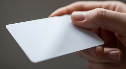 Close up of a hand holding a blank white card ideal for membership credit or ID purposes