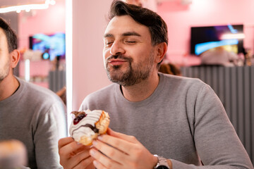 Enjoying a sweet donut treat in a trendy cafe during a cheerful afternoon